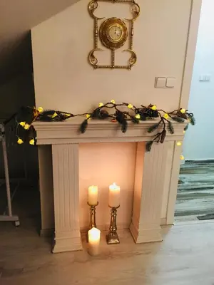 a fireplace with two candles and a clock above it at Imperial Rezidence in Prague