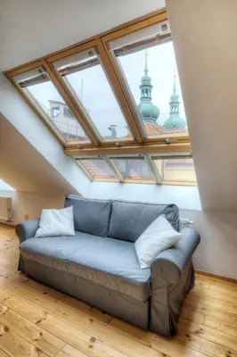 a bedroom with a large bed and a chair at Residence St Havel Prague Old Town in Prague