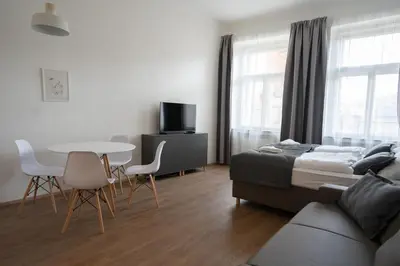 a kitchen with white cabinets and a gray counter top at Residence St Havel Prague Old Town in Prague