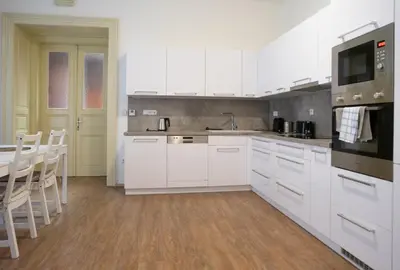 a white kitchen with white cabinets and a sink at Residence St Havel Prague Old Town in Prague