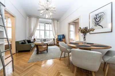 a living room with a table and chairs at Wishlist Prague Residences - Old Town Square in Prague