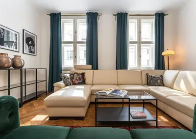 a living room with a couch and a table at Wishlist Prague Residences - Old Town Square in Prague