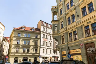 a group of buildings on a city street at Wishlist Prague Residences - Old Town Square in Prague
