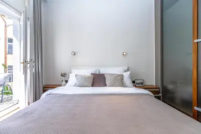 a bedroom with a large bed and a window at Wishlist Prague Residences - Old Town Bilkova in Prague
