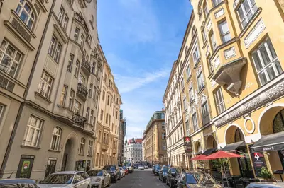 a city street with cars parked between buildings at Wishlist Prague Residences - Old Town Bilkova in Prague