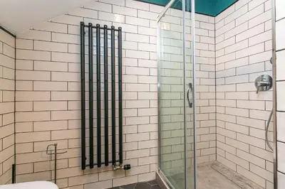 a shower with a glass door in a bathroom at Wishlist Prague Residences - Charles Bridge in Prague