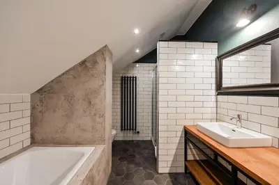 a bathroom with a tub and a sink at Wishlist Prague Residences - Charles Bridge in Prague