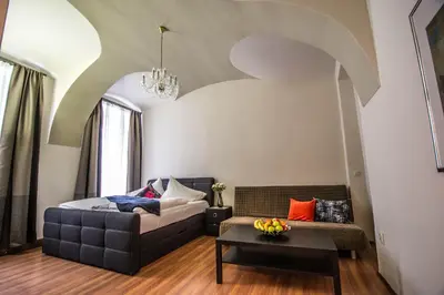 a living room with a couch and a table at 4BDR Historical Spirit Apt by Ruterra in Prague