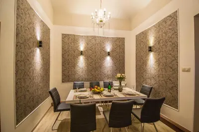 a dining room with a table and chairs and a chandelier at 4BDR Historical Spirit Apt by Ruterra in Prague
