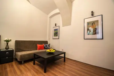 a living room with a couch and a table at 4BDR Historical Spirit Apt by Ruterra in Prague