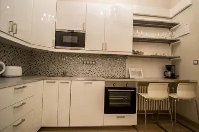 a kitchen with white cabinets and white appliances at 4BDR Historical Spirit Apt by Ruterra in Prague