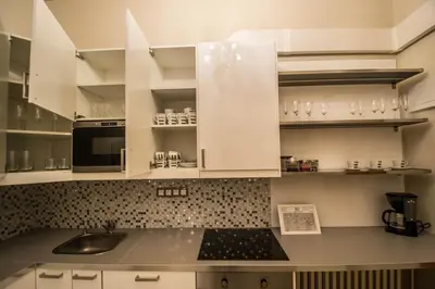 a kitchen with white cabinets and a sink at 4BDR Historical Spirit Apt by Ruterra in Prague