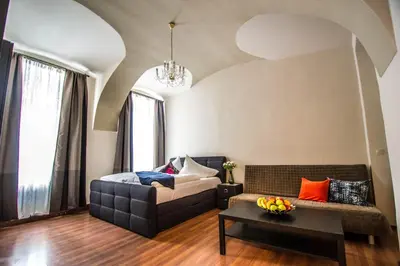 a living room with a couch and a table at 4BDR Historical Spirit Apt by Ruterra in Prague