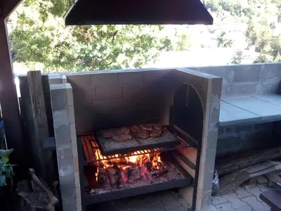 a brick oven with food cooking in it at Penzion Lida in Srbsko