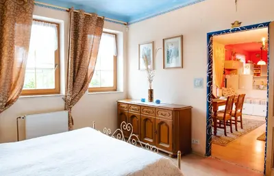 a bedroom with a bed and a dining room at Bydleni u Babicky in Bratronice