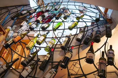 a bunch of wine bottles hanging on a wall at Bydleni u Babicky in Bratronice
