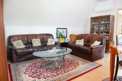 a living room with two leather couches and a table at Bydleni u Babicky in Bratronice