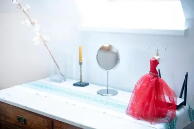 a dressing table with a red dress and a mirror at Bydleni u Babicky in Bratronice