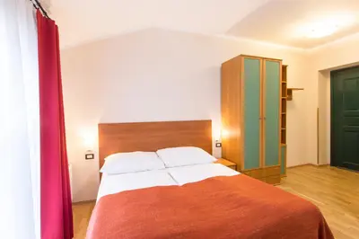 a bedroom with a bed and a green door at Duskova Apartments in Prague