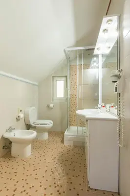 a bathroom with two sinks and a toilet and a shower at Duskova Apartments in Prague