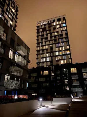 two tall buildings in a city at night at Apartment David Garden Towers in Prague