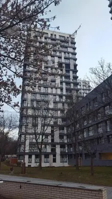 a large tall building with trees in front of it at Apartment David Garden Towers in Prague