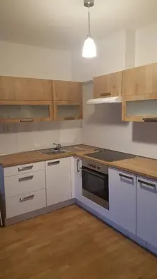 a kitchen with white cabinets and a stove top oven at Apartment David Garden Towers in Prague