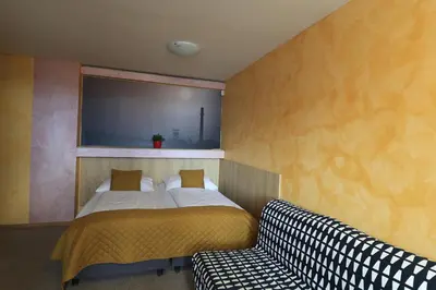 a small refrigerator in a room with a table at U Admirala in Kladno