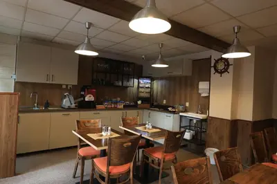 a small kitchen with a table and a small kitchen with a kitchen at U Admirala in Kladno