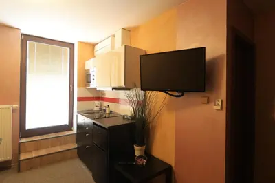 a small room with a kitchen and a mirror at U Admirala in Kladno