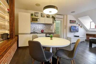 a kitchen and dining room with a table and chairs at Agnes - Apartments in Prague