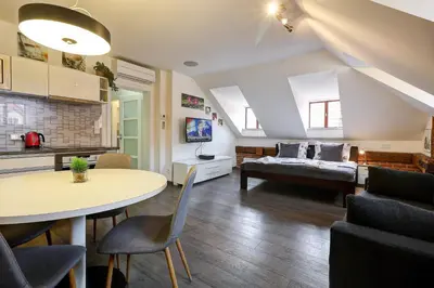 a living room with a couch and a table at Agnes - Apartments in Prague