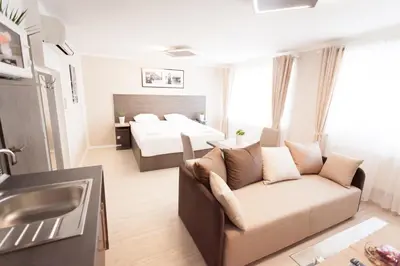 a living room with a couch and a bed at Villa Royal in Prague