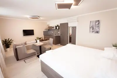 a bedroom with a bed and a living room at Villa Royal in Prague