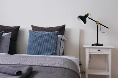a bedroom with a bed and a lamp on a table at Apartment Gesse Jirsikova in Prague