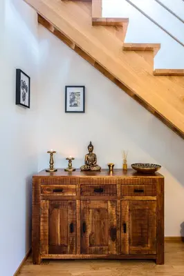 a wooden cabinet in a room under a staircase at Baranova Apartments in Prague