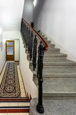 a stairway with a spiral staircase with a carpet at Baranova Apartments in Prague
