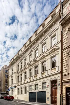 a large white building on a city street at Baranova Apartments in Prague