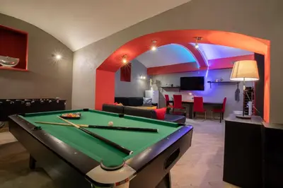 a pool table in a living room with an arch at Party Underground with Pooltable in Prague