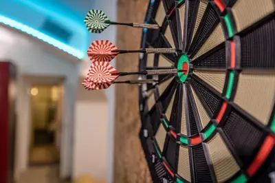 a dart board with some darts in the middle at Party Underground with Pooltable in Prague