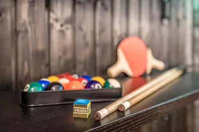 a table with a box of balls and a stick at Party Underground with Pooltable in Prague