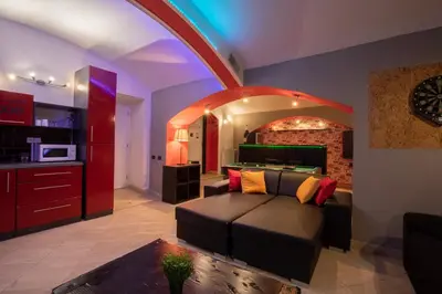 a living room with a couch and a table at Party Underground with Pooltable in Prague