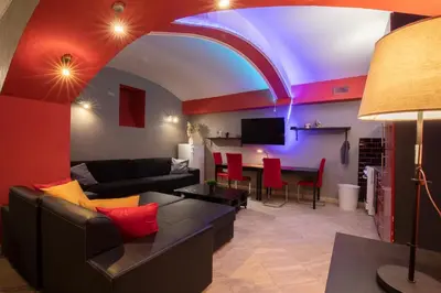 a living room with a couch and a table at Party Underground with Pooltable in Prague