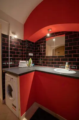 a bathroom with a washing machine and a sink at Party Underground with Pooltable in Prague
