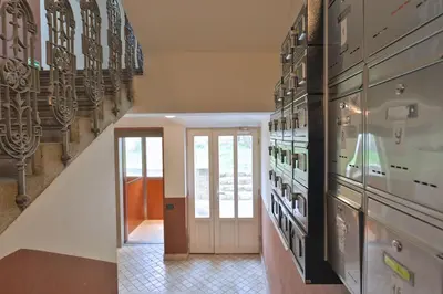 a hallway with a staircase with art on the walls at Party Underground with Pooltable in Prague