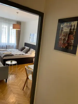 a room with a bed and a living room at Agnes - Romance in city II. in Prague