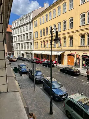 a street with cars parked on the side of the road at Agnes - Romance in city II. in Prague