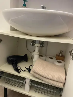 a bathroom shelf with a sink and a towel at Agnes - Romance in city II. in Prague