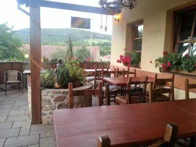 a restaurant with tables and chairs and a large window at Ubytování Steak-Hredle in Hředle