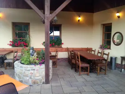 a dining room with a wooden table and chairs at Ubytování Steak-Hredle in Hředle